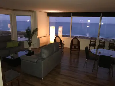 a living room with a couch and a table and chairs at Gran Apartamento, un lujo en playa El Saler - Valencia in El Saler