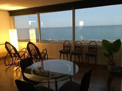 a room with a table and chairs and a large window at Gran Apartamento, un lujo en playa El Saler - Valencia in El Saler