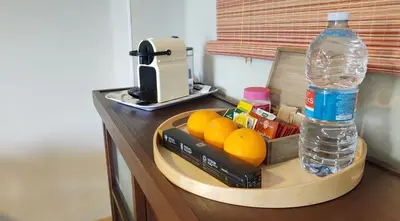 a tray with oranges and a bottle of water on a table at KOA Centric, comfy in Ruzafa in Valencia