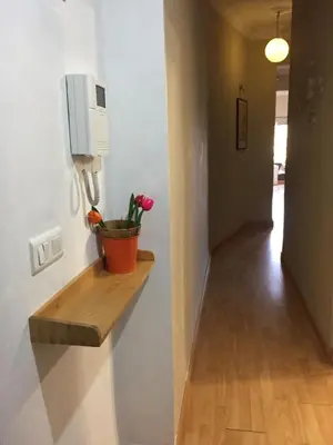 a hallway with a shelf with a flower pot on a wall at KOA Centric, comfy in Ruzafa in Valencia