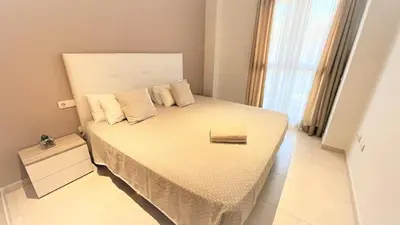 a bedroom with a large white bed with pillows at BEACH VALENCIA LUXURY A40-35 Apartment with terrace and sea views in Valencia