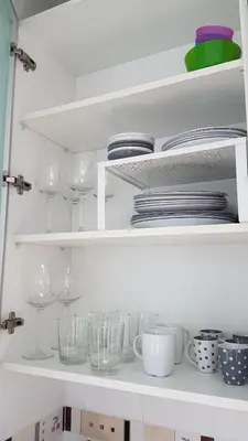 a white shelf with glasses and plates and dishes at BEACH VALENCIA LUXURY A40-35 Apartment with terrace and sea views in Valencia