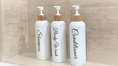 three white bottles sitting on a shelf in a bathroom at BEACH VALENCIA LUXURY A40-35 Apartment with terrace and sea views in Valencia