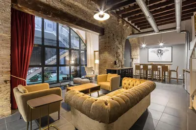 a living room with a large couch and chairs at Catalina Suites San Nicolas in Valencia
