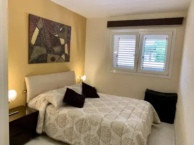 a bedroom with a bed and a window at Apartamento Nuevo con Gran Terraza y Wifi en Canet in Canet de Berenguer