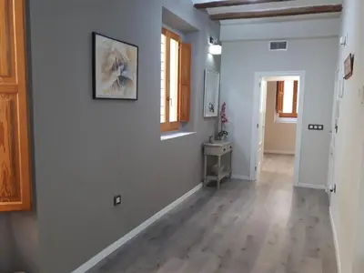 an empty hallway with white walls and wood floors at Amplio apartamento en centro histórico in Valencia