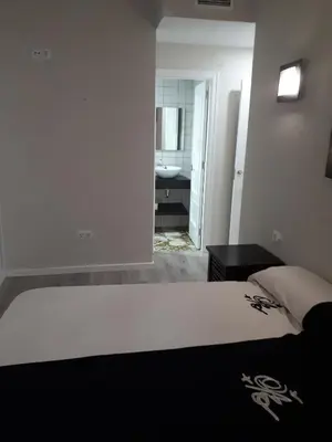 a bedroom with a bed and a bathroom with a sink at Amplio apartamento en centro histórico in Valencia