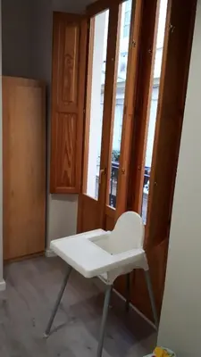 a white chair in a room with some windows at Amplio apartamento en centro histórico in Valencia