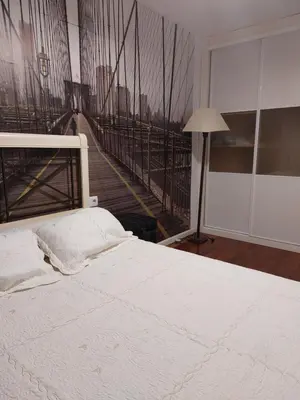 a bedroom with a white bed with a staircase in the background at Bonito piso 4 habitaciones en Bétera in Bétera