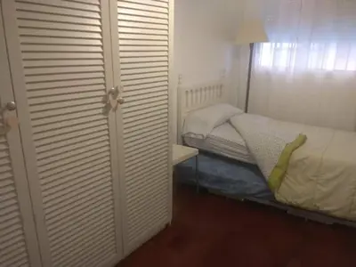 a small bedroom with a bed and a closet at Bonito piso 4 habitaciones en Bétera in Bétera