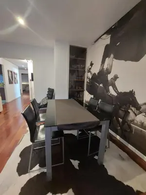 a dining room with a table and a horse mural at Bonito piso 4 habitaciones en Bétera in Bétera