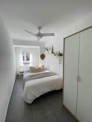 a white bedroom with a bed and a mirror at Beach Malvarrosa, Cabañal, Wifi free. Ca' Micaela. in Valencia