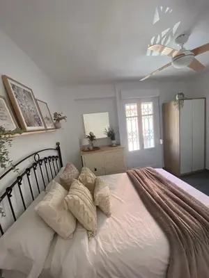a bedroom with a large white bed with pillows at Beach Malvarrosa, Cabañal, Wifi free. Ca' Micaela. in Valencia