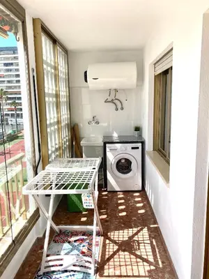 a laundry room with a washing machine and a window at Apartamento en la playa Arensol Cullera in Cullera