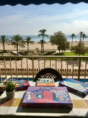 a table with pillows on it with a view of the beach at Apartamento en la playa Arensol Cullera in Cullera