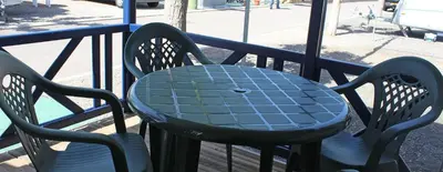 a blue table and two chairs on a balcony at Camping y Bungalows Monmar in Moncófar