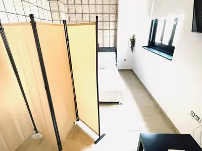 a row of stalls in a room with a window at Valentia Apartments - Mercado Central in Valencia