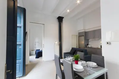 a dining room and living room with a table and chairs at Valentia Apartments - Mercado Central in Valencia