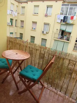 a table and chairs on a balcony with a building at Apartamento Playa Malvarrosa, Valencia in Valencia