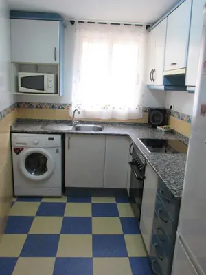 a kitchen with a sink and a washing machine at Apartamento Playa Malvarrosa, Valencia in Valencia