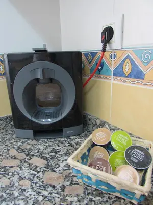 a microwave sitting on a counter with a basket of cookies at Apartamento Playa Malvarrosa, Valencia in Valencia