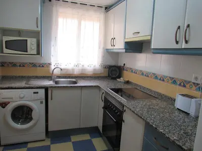 a kitchen with a sink and a washing machine at Apartamento Playa Malvarrosa, Valencia in Valencia