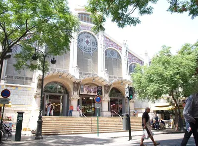 a building on a street with people walking in front of it at ApartUP L' Almoina in Valencia
