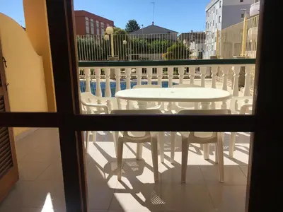 a view of a table and chairs from a window at Apartamentos Satse Moncofa in Moncófar