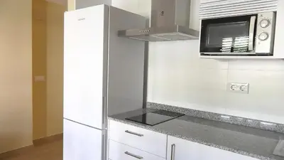 a kitchen with a white refrigerator and a microwave at Apartamentos Satse Moncofa in Moncófar