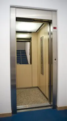 an elevator door in a building with a mirror at Hostal Casa Paco in Chilches