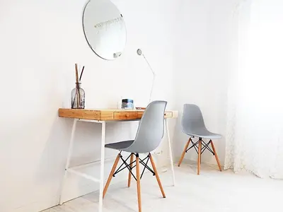 a desk and two chairs in a room with a mirror at Campanar Flat in Valencia