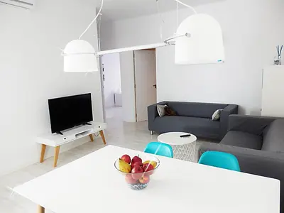 a living room with a table with a bowl of fruit on it at Campanar Flat in Valencia