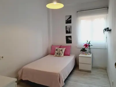 a bedroom with a bed with pink pillows on it at Campanar Flat in Valencia