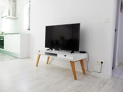 a flat screen tv on a table in a living room at Campanar Flat in Valencia