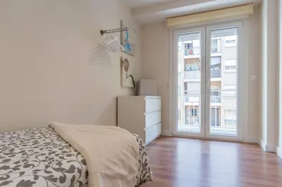 a bedroom with a bed and a large window at Cedro flat in Valencia