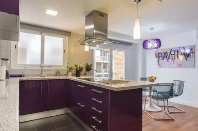 a kitchen with purple cabinets and a counter top at Cedro flat in Valencia