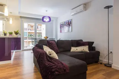 a living room with a brown couch with pillows at Cedro flat in Valencia