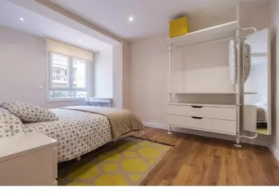 a bedroom with a bed and a dresser with a television at Cedro flat in Valencia