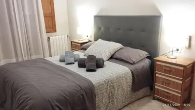 a bedroom with a bed with two towels on it at Apartamento céntrico Torres de Quart. in Valencia