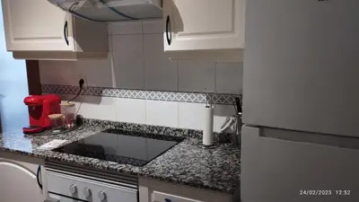 a kitchen with white cabinets and granite counter tops at Apartamento céntrico Torres de Quart. in Valencia