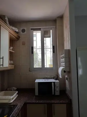 a kitchen with a microwave on a counter with a window at Bianca in Valencia