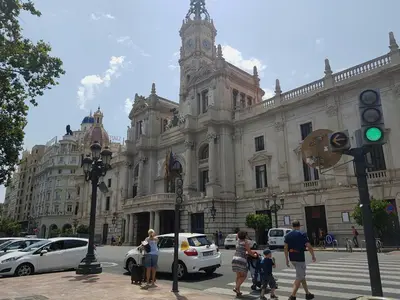 a group of people crossing a street in front of a building at Bianca in Valencia