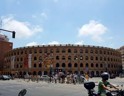 a man on a motorcycle in front of a large building at Bianca in Valencia