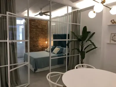 a room with a bed and a table and chairs at Apartamento Frederick “Centrico y con Clase” in Valencia