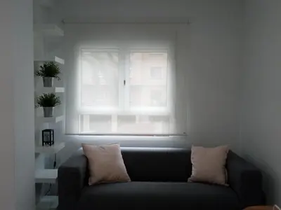 a couch in a living room with a window at Loft Office in Valencia