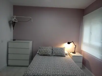 a small bedroom with a bed and a lamp at Loft Office in Valencia