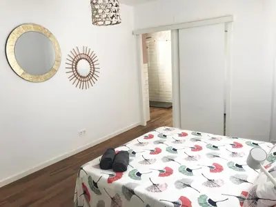 a bedroom with a bed and a mirror on the wall at Goya atico in Valencia