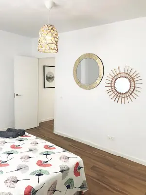 a bedroom with a bed and a mirror on the wall at Goya atico in Valencia