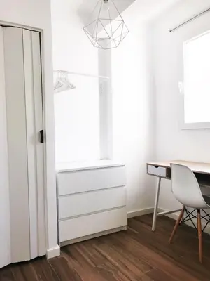 a white room with a desk and a window at Goya atico in Valencia