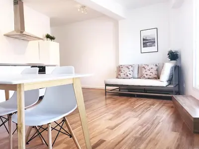 a living room with a table and a couch at Goya atico in Valencia